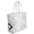 White tote bag with black geometric patterns featuring squares, diamonds, and triangles. Royalty Free Stock Photo