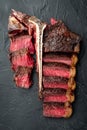 T bone steak is grilled sliced on a piece. Aged Barbecue Porterhouse Steak, on black stone background, top view flat lay