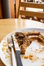 T-bone steak leftover on white plate.