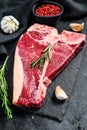 T bone steak. Organic raw Tbon beef. Black background. Top view
