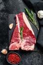 T bone steak. Organic raw Tbon beef. Black background. Top view