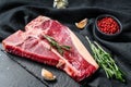 T bone steak. Organic raw Tbon beef. Black background. Top view