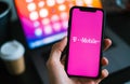 T-mobile logo on the smartphone screen in hand