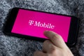 T-Mobile is a mobile communications company. TMobile App on iPhone 11 with Vodafone logo. Royalty Free Stock Photo