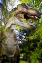 T-Rex Tyrannosaurus rex. Dinosaur model in the forest through