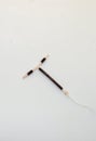 T shape IUD Gold hormon free birth control device on white background. Selective focus