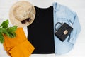 T shirt black. T-shirt Mockup flat lay with summer accessories. Hat, bag and sunglasses on wooden floor background. Copy space. Royalty Free Stock Photo