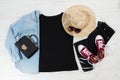 T shirt black. T-shirt Mockup flat lay with summer accessories. Hat, bag and sunglasses on wooden floor background. Copy space. Royalty Free Stock Photo