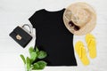 T shirt black and slippers. T-shirt Mockup flat lay with summer accessories. Hat, bag, yellow flip flops and sunglasses on wooden Royalty Free Stock Photo