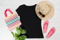 T shirt black and slippers. T-shirt Mockup flat lay with summer accessories. Hat, bag, red flip flops and sunglasses on wooden Royalty Free Stock Photo