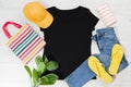 T shirt black and slippers. T-shirt Mockup flat lay with summer accessories. Hat, bag, yellow flip flops on wooden floor Royalty Free Stock Photo