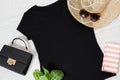 T shirt black. T-shirt Mockup flat lay with summer accessories. Hat, bag and sunglasses on wooden floor background. Copy space. Royalty Free Stock Photo