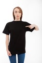 T-shirt design, happy girl concept of smiling woman in blank template black shirt pointing her fingers at herself. Royalty Free Stock Photo