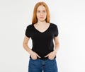 T-shirt design, happy people concept - smiling red hair woman in blank black t-shirt pointing her fingers at herself, red head Royalty Free Stock Photo