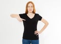 T-shirt design, happy people concept - smiling red hair woman in blank black t-shirt pointing her fingers at herself, red head Royalty Free Stock Photo