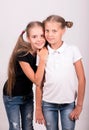 two girlfriends. Cute happy girls in black and white t-shirt on a white background. Royalty Free Stock Photo