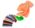 T-shirt flies out of a pile with clothes on white background Royalty Free Stock Photo