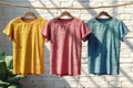 T-Shirts on Clothes Line on a white brick wall Royalty Free Stock Photo