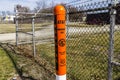 Indianapolis - Circa February 2017: AT&T Warning Post marking underground cables and a note to call 811 before digging I Royalty Free Stock Photo