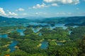 Ta Dung lake in the summer. Blue sky and cloudy on the lake and the trees on the small island paradise. Dak Nong global geological