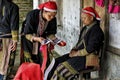 Red Dao women sewing in the village.