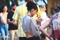 Ta`Qali, Malta - June 04 2022: A young woman checking her phone at a crowded event