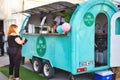 Ta-Qali, Malta - May 20 2022: A woman wearing a mask ordering food from a mobile snack bar