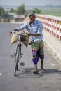 A man riding a bicycle using throws transportation purpose in the village of Gorpara, Manikgonj , Bangladesh. Royalty Free Stock Photo