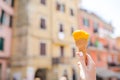 Taasty sweet ice-cream closeup in female hands background old italian village Royalty Free Stock Photo