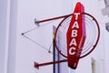 Tabac red round sign of French shop logo for tobacco with white text on wall