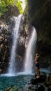 Tabanan - A man stanging in front of a Gitgit Twin Waterfall