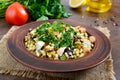 Tabbouleh - hot salad of couscous, meat, fried vegetables and parsley Royalty Free Stock Photo