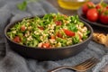 Tabbouleh salad with bulgur, parsley, spring onion and tomato in bowl on grey background. Top view. WIth copy space Royalty Free Stock Photo