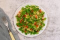 Tabbouleh salad with bulgur, parsley, spring onion and tomato in bowl on grey background. Top view Royalty Free Stock Photo