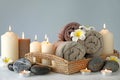 Beautiful spa composition with burning candles and towels on table Royalty Free Stock Photo