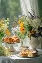 Table Adorned With Pastries and Flowers by Window