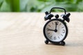 Table alarm clock pointing at 9pm or 9am with customizable space for text. Time management concept and copy space