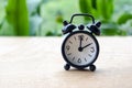 Table alarm clock pointing at 2pm or 2am with customizable space for text. Time management concept and copy space