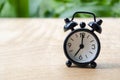 Table alarm clock pointing at 7pm or 7am with customizable space for text. Time management concept and copy space