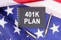 On the table is an American flag, a pen and a notebook with the inscription - 401K PLAN