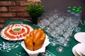 A table of appetizers. Russian pies, a plate of mini mozzarella canapÃÂ©s with cherry tomatoes