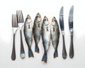 A table arrangement featuring silver fish forks and knives Royalty Free Stock Photo