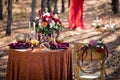 The table with an autumn decor laid for two in the wood