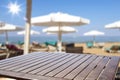 Table background with beautiful blue ocean and sandy beach view. A table with chairs and the sea in distance. Summer sunny day.