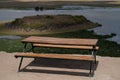 Table and bench on the edge of a cliff overlooking a river Royalty Free Stock Photo