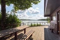 Table and benches for relaxing by the lake near a wooden country house Royalty Free Stock Photo