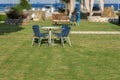 Table and blue four chair in the garden with green lawn grass Royalty Free Stock Photo