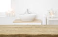 Table board before heavily blurred spa salon bathroom shelves background Royalty Free Stock Photo