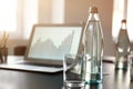 Table with bottle of water prepared for business meeting in conference hall Royalty Free Stock Photo