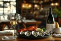 A table set with a bottle of wine, a plate of oysters, and a filled wine glass. Royalty Free Stock Photo